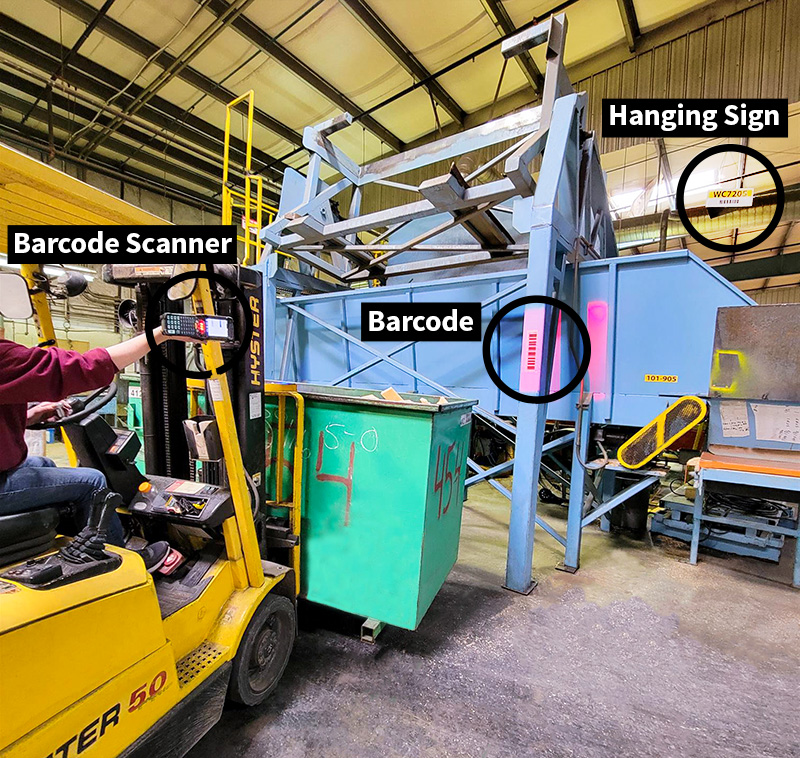 Forklift driver scanning new location signs