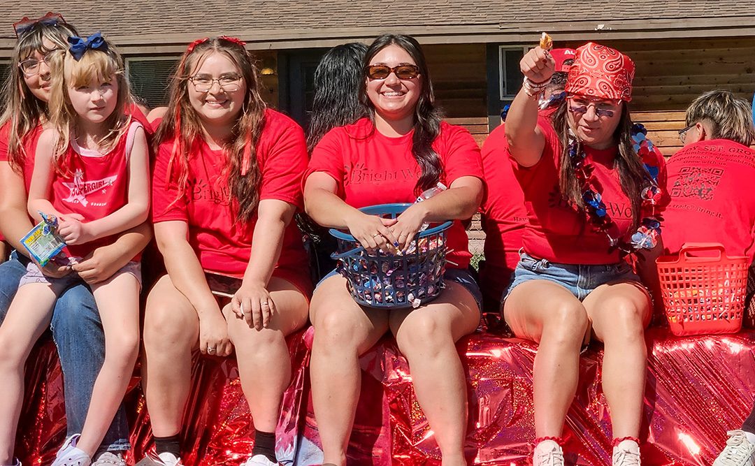 Seated women smiling with candy baskets